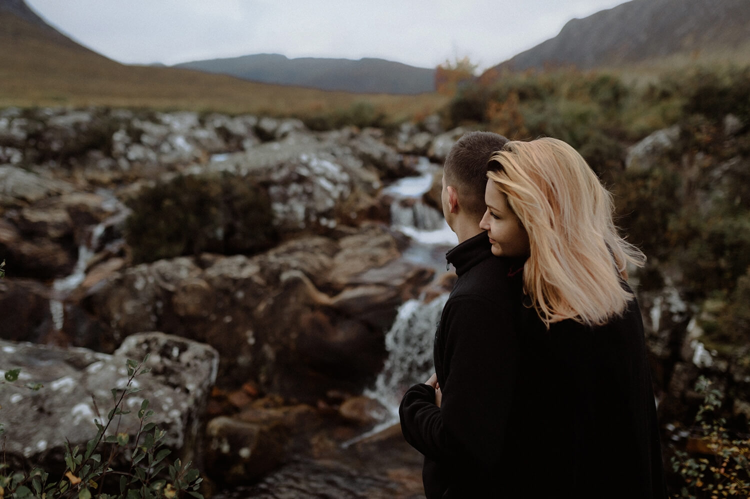 Couple portrait near a waterfall in Scotland.